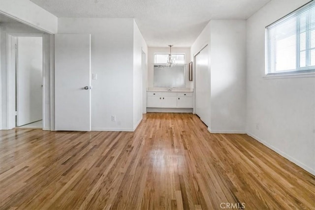 1129 Belbury Dr, Walnut, CA 91789 - unfurnished room with a chandelier, light wood-type flooring, and healthy amount of natural light