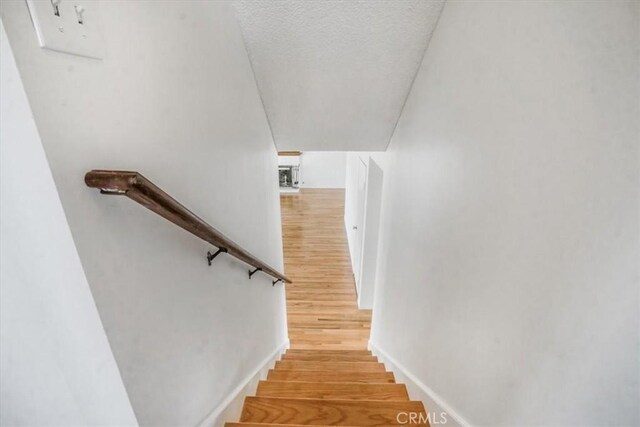1129 Belbury Dr, Walnut, CA 91789 - stairs with wood finished floors and a textured ceiling