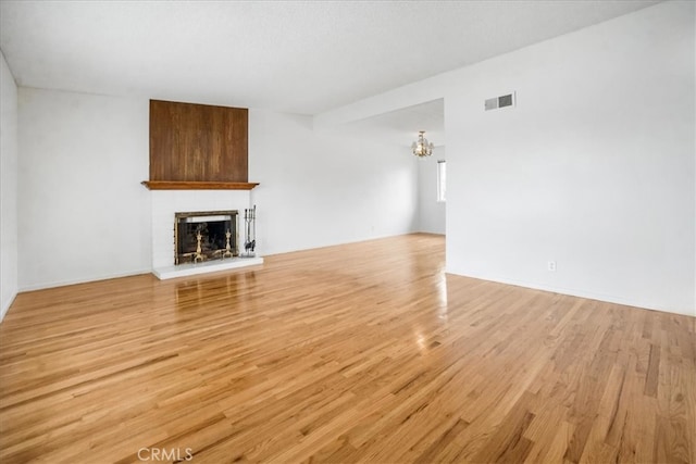 1129 Belbury Dr, Walnut, CA 91789 - unfurnished living room with a fireplace, light wood finished floors, and a chandelier