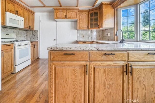 1129 Belbury Dr, Walnut, CA 91789 - kitchen featuring white appliances, light stone counters, tasteful backsplash, glass insert cabinets, and light wood-style floors