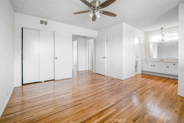 1129 Belbury Dr, Walnut, CA 91789 - unfurnished bedroom with light wood-style flooring, a chandelier, a textured ceiling, ensuite bath, and a closet