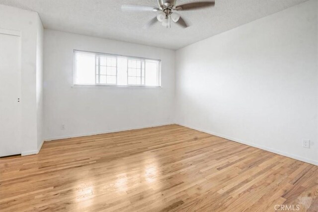 1129 Belbury Dr, Walnut, CA 91789 - unfurnished bedroom featuring a textured ceiling, wood finished floors, a ceiling fan, and a closet