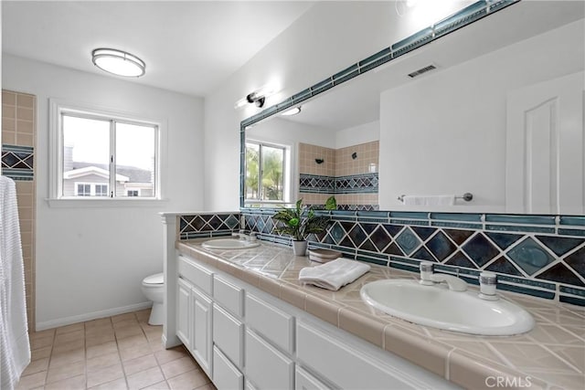 558 24th St, Hermosa Beach, CA 90254 - bathroom with double vanity, tasteful backsplash, a tile shower, and tile patterned flooring