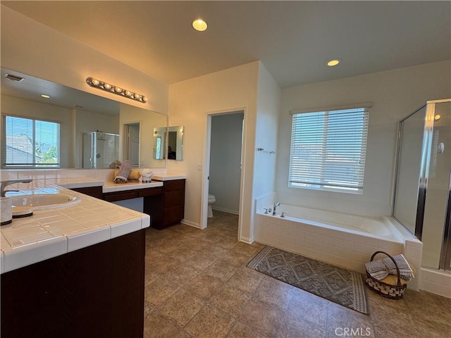 33314 Lazurite Way, Menifee, CA 92584 - bathroom with vanity, a stall shower, a bath, and recessed lighting