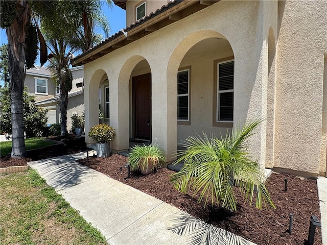 33314 Lazurite Way, Menifee, CA 92584 - doorway to property featuring stucco siding and a tiled roof