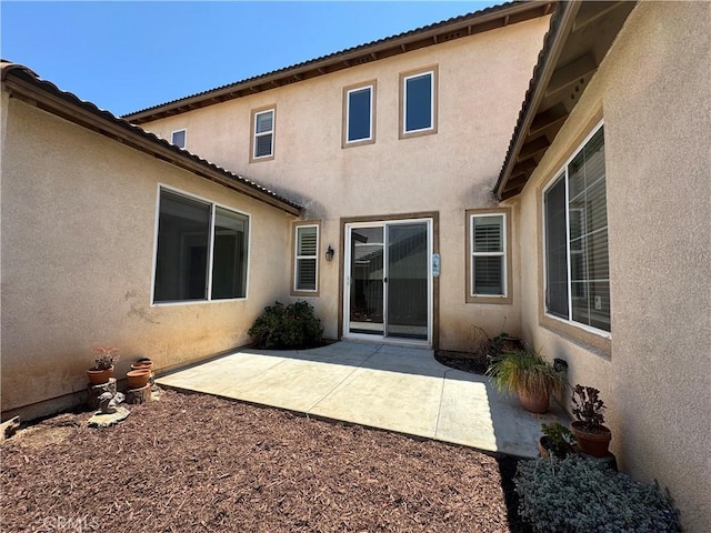 33314 Lazurite Way, Menifee, CA 92584 - rear view of house with stucco siding and a patio area