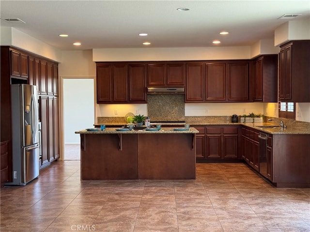 33314 Lazurite Way, Menifee, CA 92584 - kitchen featuring stainless steel appliances, under cabinet range hood, stone countertops, a kitchen island with sink, and recessed lighting