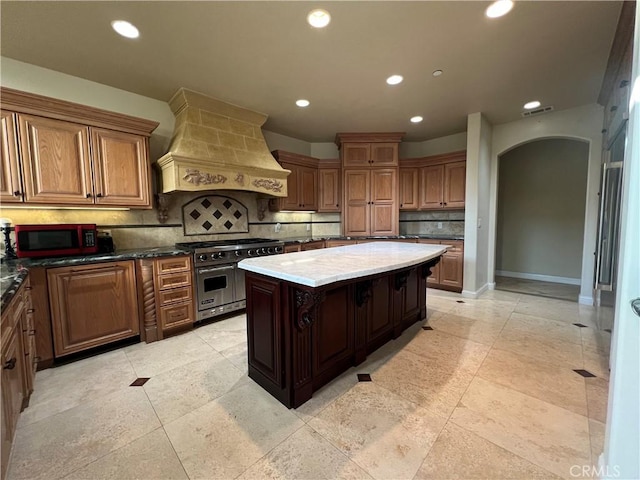 1685 Scenic View Way, Nipomo, CA 93444 - kitchen featuring custom exhaust hood, double oven range, arched walkways, decorative backsplash, and recessed lighting