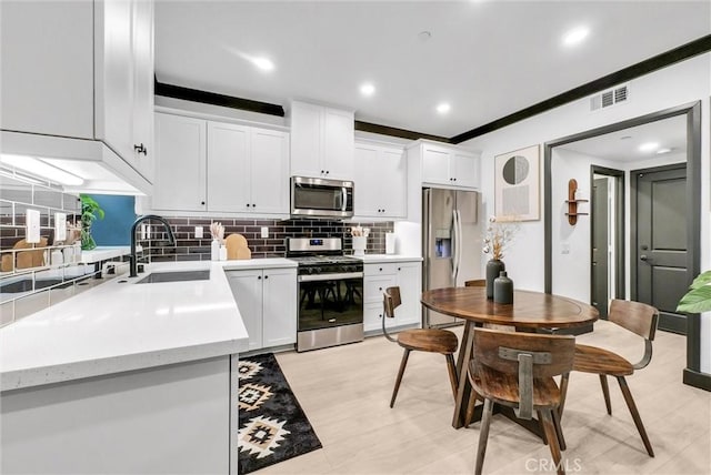 12342 Blue Sky Ct, Whittier, CA 90602 - kitchen featuring appliances with stainless steel finishes, tasteful backsplash, white cabinetry, and recessed lighting