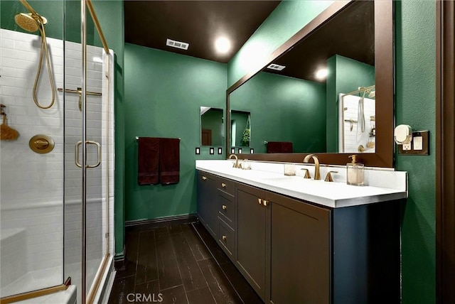 12342 Blue Sky Ct, Whittier, CA 90602 - bathroom with a shower stall, double vanity, and wood finished floors