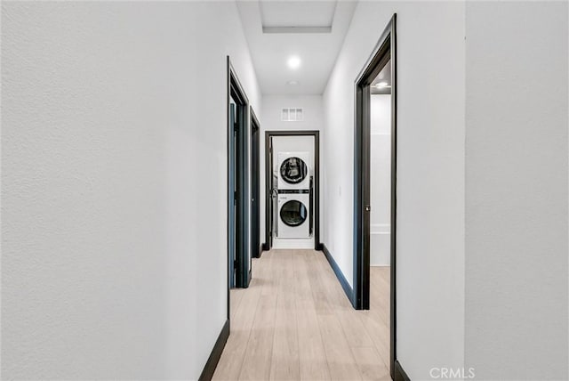 12342 Blue Sky Ct, Whittier, CA 90602 - corridor with stacked washing machine and dryer and light wood-style floors