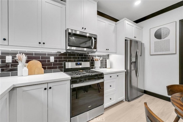 12342 Blue Sky Ct, Whittier, CA 90602 - kitchen with stainless steel appliances, light countertops, light wood-style flooring, and decorative backsplash