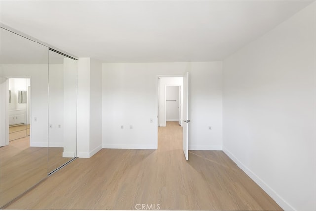 2386 Via Mariposa W Unit 2B, Laguna Woods, CA 92637 - unfurnished bedroom with light wood-type flooring and a closet