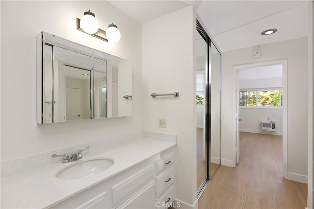 2386 Via Mariposa W Unit 2B, Laguna Woods, CA 92637 - bathroom featuring vanity, wood finished floors, and an AC wall unit