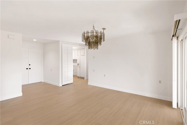 2386 Via Mariposa W Unit 2B, Laguna Woods, CA 92637 - spare room with light wood-style flooring and a chandelier