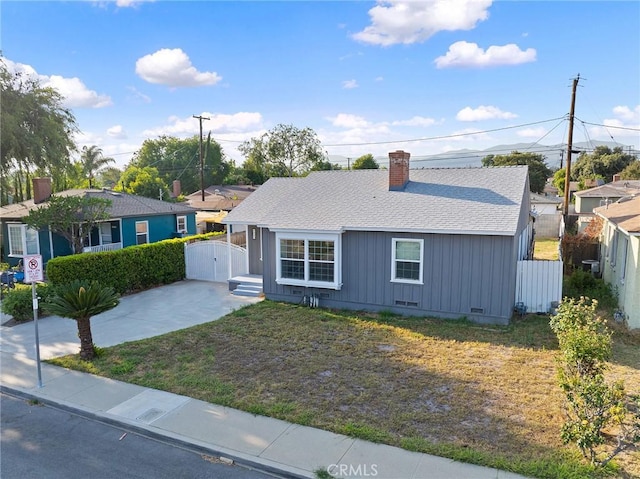 1517 W Grand Ave, Pomona, CA 91766 - view of front of home featuring a gate, a chimney, crawl space, and a shingled roof