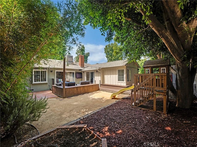 15017 Archwood St, Van Nuys, CA 91405 - back of property featuring a chimney, board and batten siding, a patio area, a playground, and outdoor lounge area