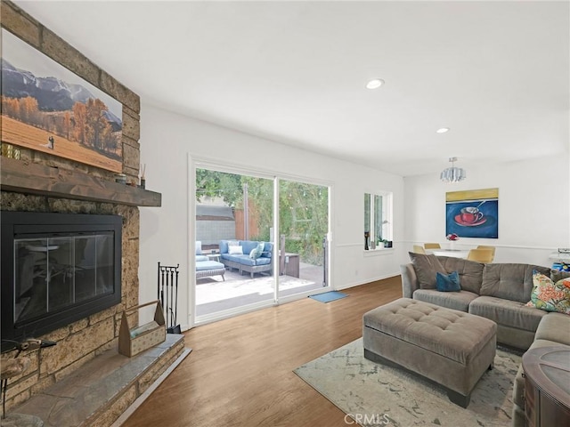 15017 Archwood St, Van Nuys, CA 91405 - living area with a stone fireplace, wood finished floors, and recessed lighting