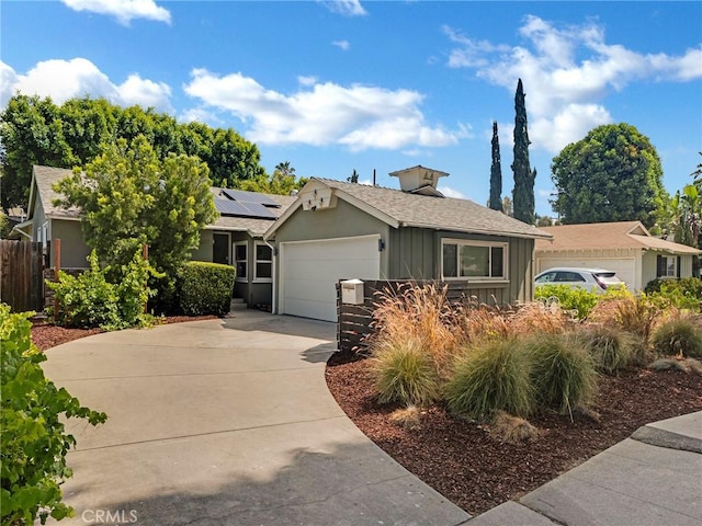 15017 Archwood St, Van Nuys, CA 91405 - ranch-style house featuring roof mounted solar panels, an attached garage, board and batten siding, and driveway