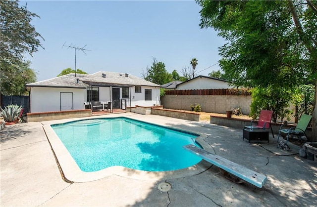 17330 Califa St, Encino, CA 91316 - view of pool with a patio, a fenced backyard, an outdoor fire pit, and a diving board