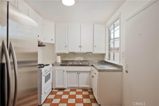 17330 Califa St, Encino, CA 91316 - kitchen featuring stainless steel countertops, freestanding refrigerator, white gas stove, white cabinetry, and light floors