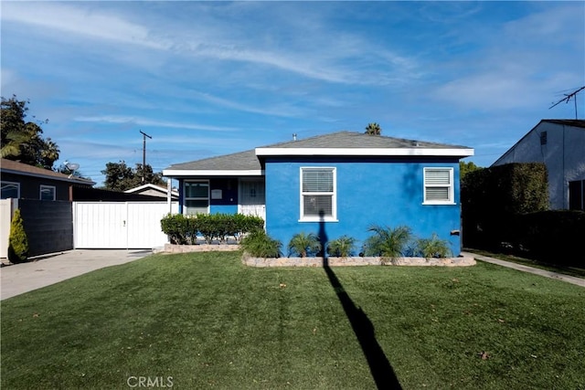 2561 E Washington St, Carson, CA 90810 - view of front facade with a gate and stucco siding