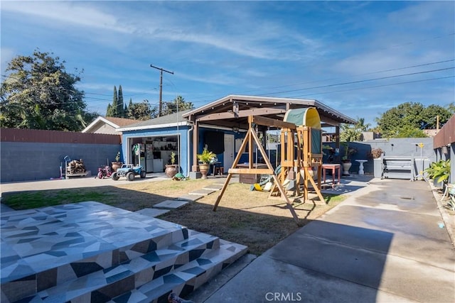 2561 E Washington St, Carson, CA 90810 - back of house featuring a fenced backyard and a playground