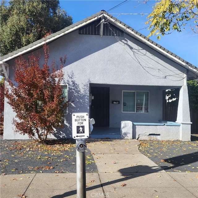 1048 W 5th St, Chico, CA 95928 - view of front of property featuring covered porch and stucco siding