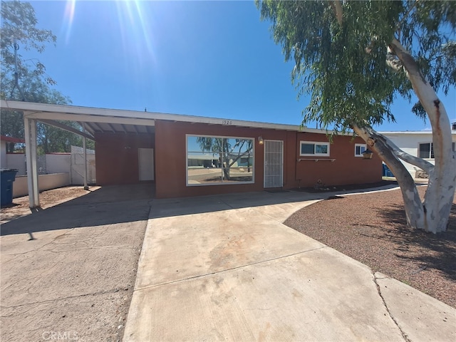 1920 Flora, Needles, CA 92363 - view of front facade with concrete driveway and an attached carport