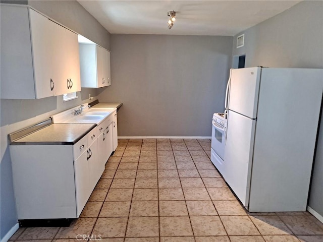 1920 Flora, Needles, CA 92363 - kitchen featuring white appliances, white cabinetry, and light tile patterned floors