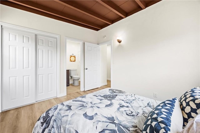 4003 Puente Ave, Baldwin Park, CA 91706 - bedroom featuring beam ceiling, light wood-style flooring, ensuite bathroom, and a closet