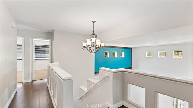 31850 Camino Marea, Temecula, CA 92592 - hallway featuring dark wood-style floors, a chandelier, and an upstairs landing