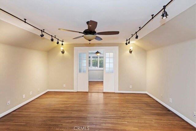 1350 E Chase Dr, Corona, CA 92881 - spare room with track lighting, ceiling fan, wood finished floors, and lofted ceiling