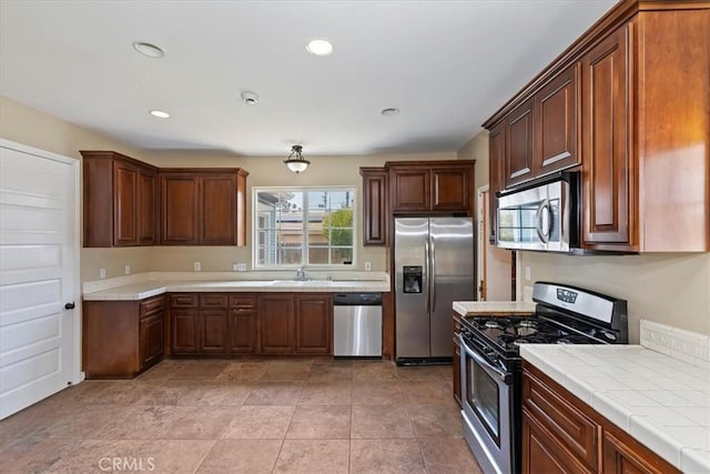 1350 E Chase Dr, Corona, CA 92881 - kitchen with stainless steel appliances, tile counters, and recessed lighting