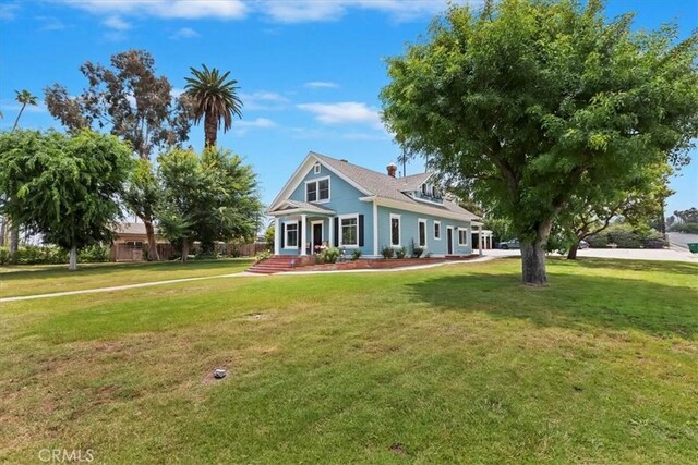 1350 E Chase Dr, Corona, CA 92881 - view of front facade featuring a front lawn and a chimney