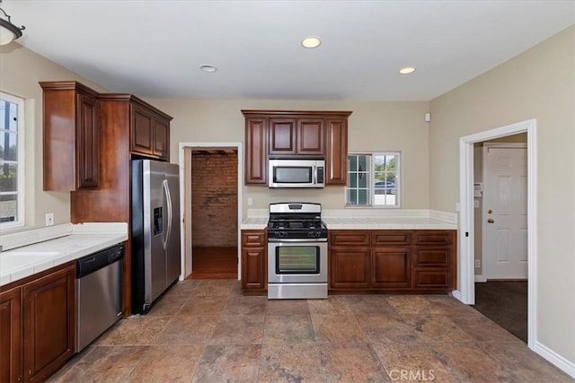 1350 E Chase Dr, Corona, CA 92881 - kitchen featuring stainless steel appliances, tile countertops, dark stone finish floors, and recessed lighting