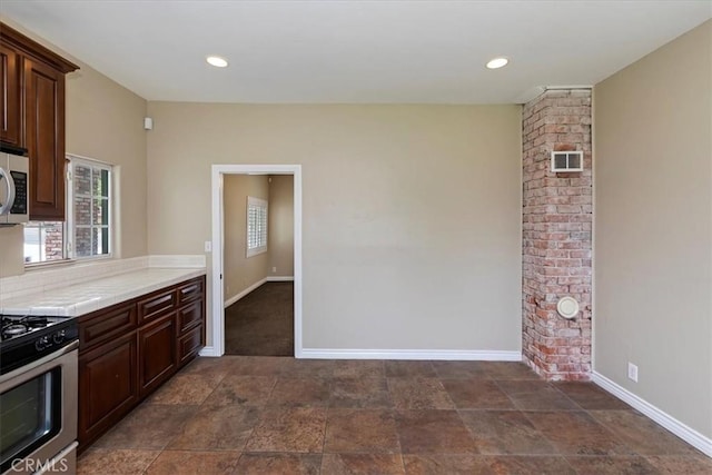 1350 E Chase Dr, Corona, CA 92881 - kitchen with appliances with stainless steel finishes, tile counters, dark brown cabinets, and recessed lighting