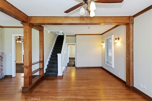 1350 E Chase Dr, Corona, CA 92881 - unfurnished living room with ceiling fan, wood finished floors, beam ceiling, stairway, and ornamental molding