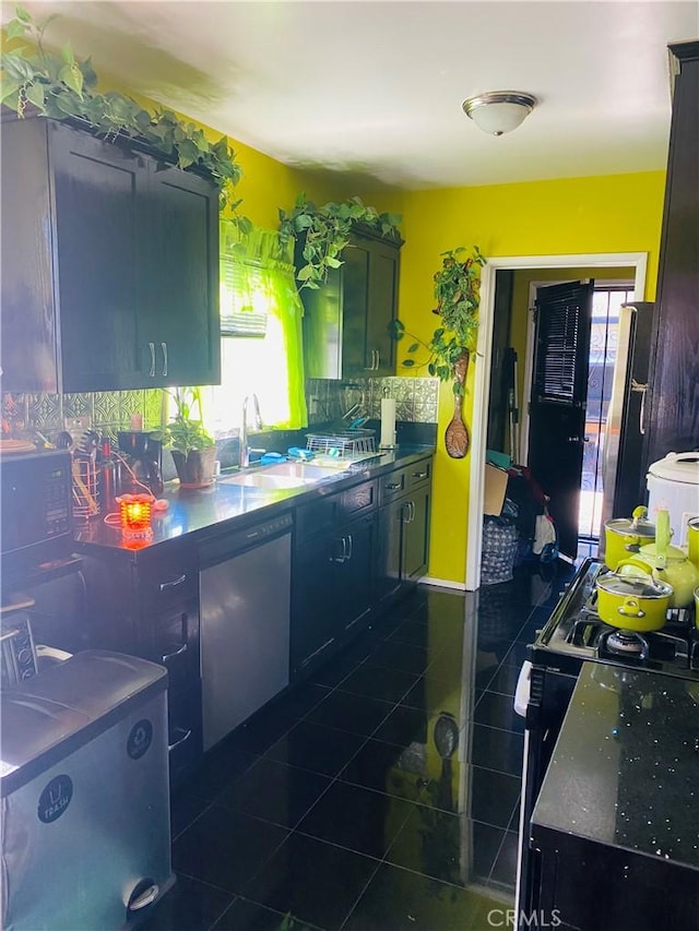 2737 W Caldwell St, Carson, CA 90220 - kitchen featuring dark tile patterned flooring, healthy amount of natural light, and black gas range