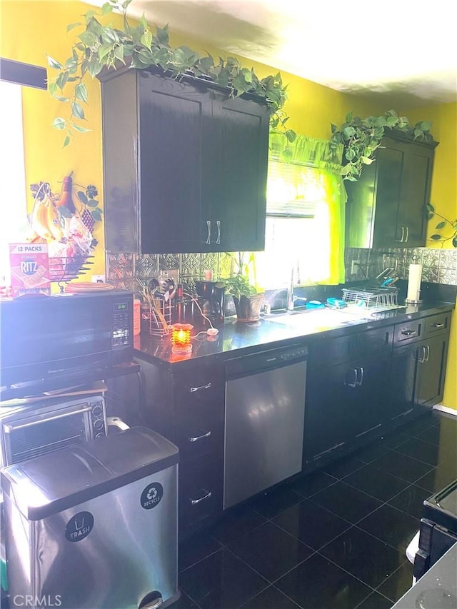 2737 W Caldwell St, Carson, CA 90220 - kitchen featuring fridge, dark countertops, and tasteful backsplash