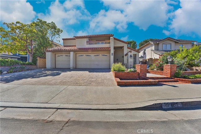 28161 Haria, Mission Viejo, CA 92692 - mediterranean / spanish home with decorative driveway, a tiled roof, stucco siding, and a garage
