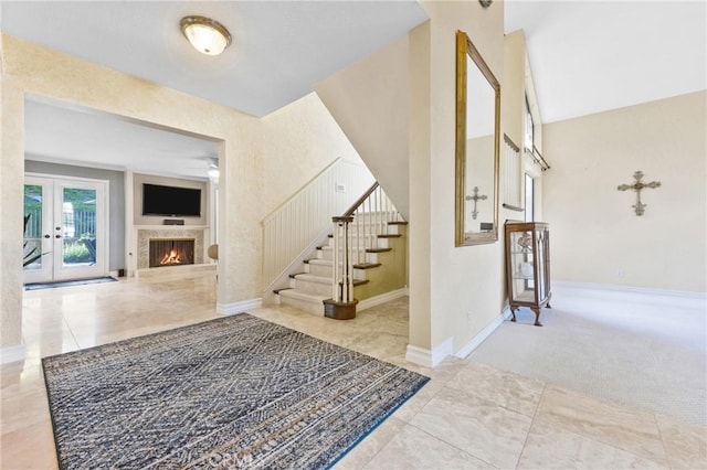 28161 Haria, Mission Viejo, CA 92692 - foyer entrance with stairs, a warm lit fireplace, a high ceiling, and french doors