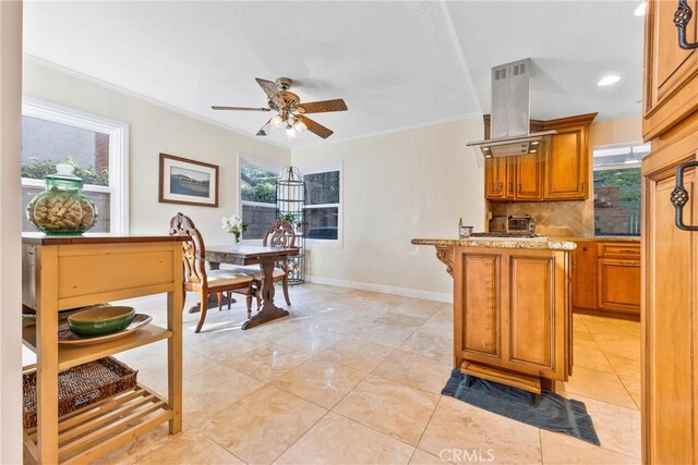 28161 Haria, Mission Viejo, CA 92692 - kitchen with island exhaust hood, brown cabinetry, ceiling fan, crown molding, and backsplash