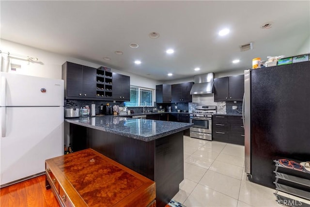 1454 Ameluxen Ave, Hacienda Heights, CA 91745 - kitchen featuring appliances with stainless steel finishes, wall chimney range hood, decorative backsplash, a peninsula, and dark stone counters