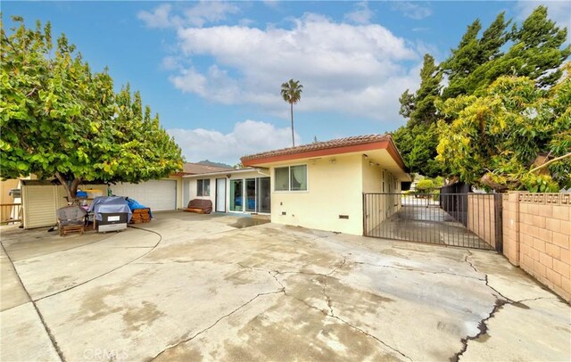 1454 Ameluxen Ave, Hacienda Heights, CA 91745 - back of property with driveway, a gate, stucco siding, a tiled roof, and an attached garage