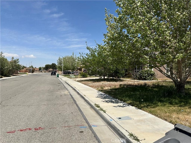 37920 Pisces Cir, Palmdale, CA 93552 - view of asphalt road featuring street lighting, sidewalks, and curbs