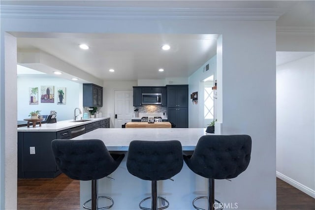 2091 Ridgeview, Corona, CA 92882 - kitchen featuring appliances with stainless steel finishes, a peninsula, a breakfast bar area, light countertops, and ornamental molding