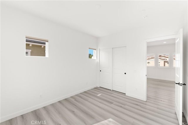 1359 Point Loma Pl, Walnut, CA 91789 - unfurnished bedroom with light wood finished floors, multiple windows, and a closet