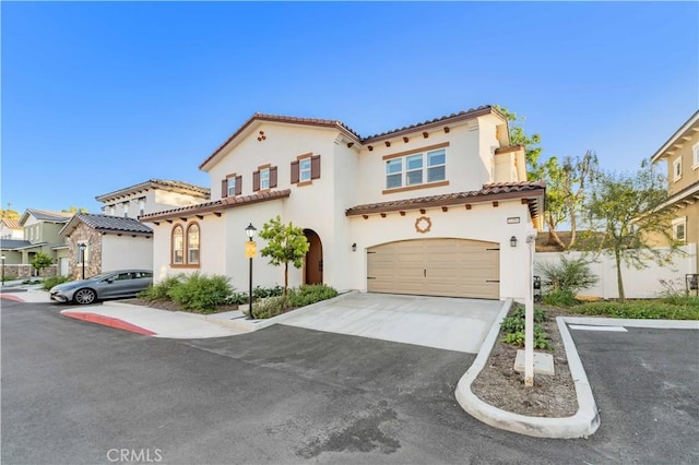 1359 Point Loma Pl, Walnut, CA 91789 - mediterranean / spanish-style home featuring a tiled roof, a garage, stucco siding, and driveway