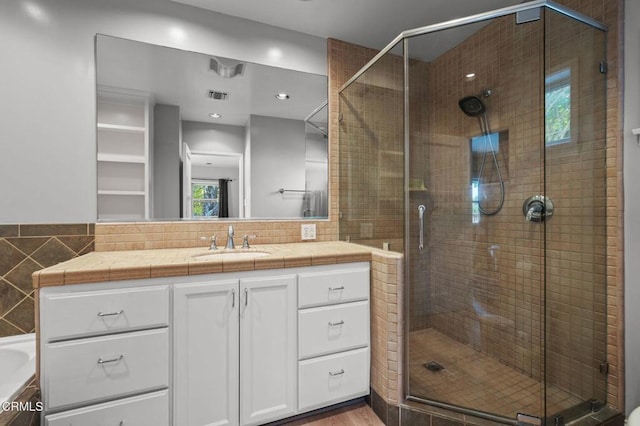664 Monterey Rd, South Pasadena, CA 91030 - bathroom featuring vanity, a shower stall, a tub to relax in, wood finished floors, and tile walls